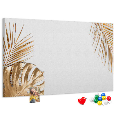 Pizarra de corcho con diseño de hojas doradas sobre fondo blanco