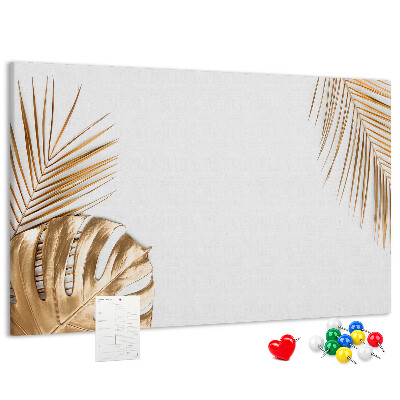 Pizarra de corcho con diseño de hojas doradas sobre fondo blanco