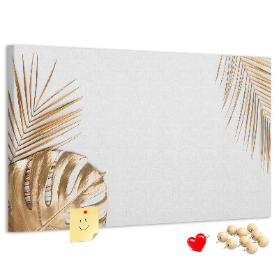 Pizarra de corcho con diseño de hojas doradas sobre fondo blanco