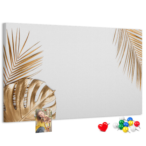 Pizarra de corcho con diseño de hojas doradas sobre fondo blanco