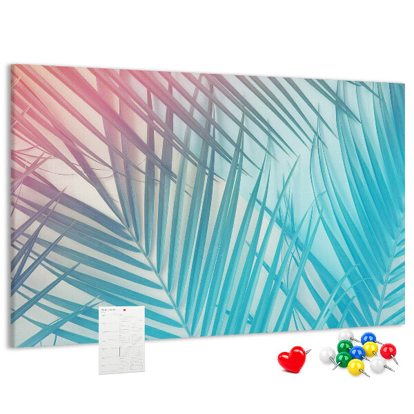 Pizarra de corcho con diseño de hojas tropicales sobre fondo pastel