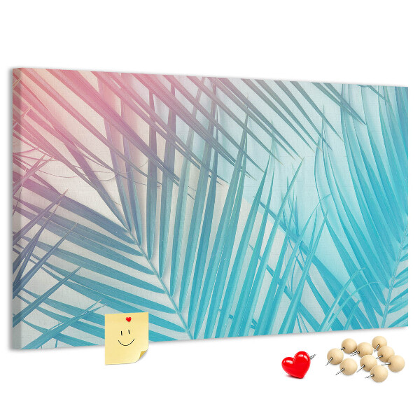 Pizarra de corcho con diseño de hojas tropicales sobre fondo pastel