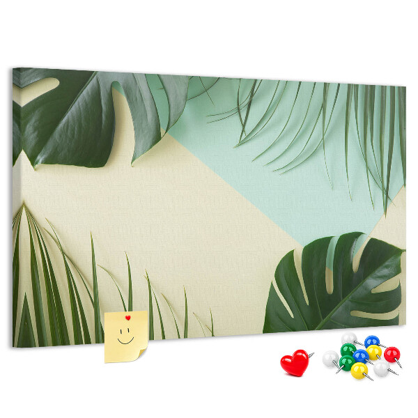 Tablero de corcho decorativo con diseño de hojas tropicales sobre fondo pastel