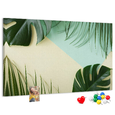 Tablero de corcho decorativo con diseño de hojas tropicales sobre fondo pastel