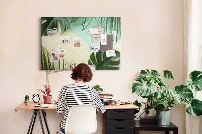 Tablero de corcho decorativo con diseño de hojas tropicales sobre fondo pastel