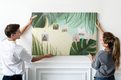 Tablero de corcho decorativo con diseño de hojas tropicales sobre fondo pastel