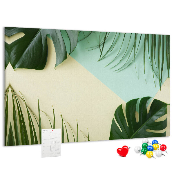 Tablero de corcho decorativo con diseño de hojas tropicales sobre fondo pastel