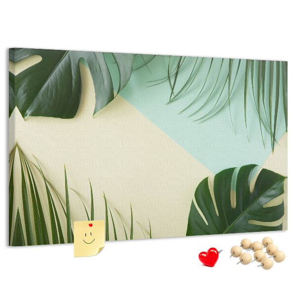 Tablero de corcho decorativo con diseño de hojas tropicales sobre fondo pastel