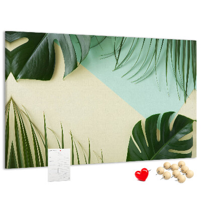 Tablero de corcho decorativo con diseño de hojas tropicales sobre fondo pastel