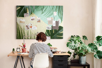 Tablero de corcho decorativo con diseño de hojas tropicales sobre fondo pastel