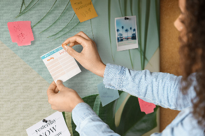 Tablero de corcho decorativo con diseño de hojas tropicales sobre fondo pastel
