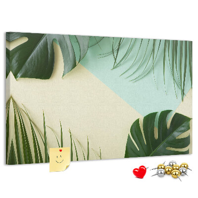 Tablero de corcho decorativo con diseño de hojas tropicales sobre fondo pastel