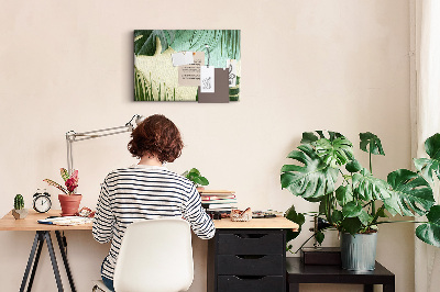 Tablero de corcho decorativo con diseño de hojas tropicales sobre fondo pastel