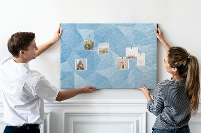 Pizarra de corcho con diseño de triángulos geométricos en tonalidades azules