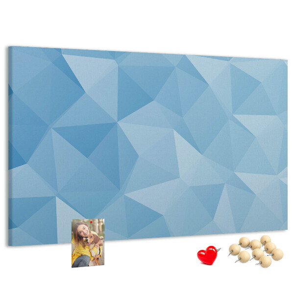 Pizarra de corcho con diseño de triángulos geométricos en tonalidades azules
