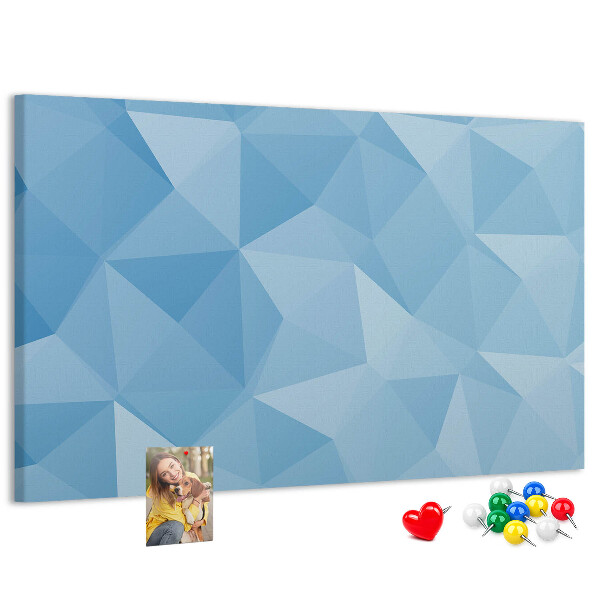 Pizarra de corcho con diseño de triángulos geométricos en tonalidades azules