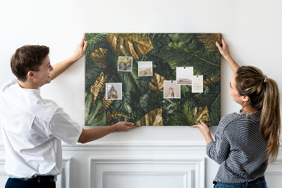Tablero de corcho decorado con diseño de hojas doradas sobre fondo verde oscuro