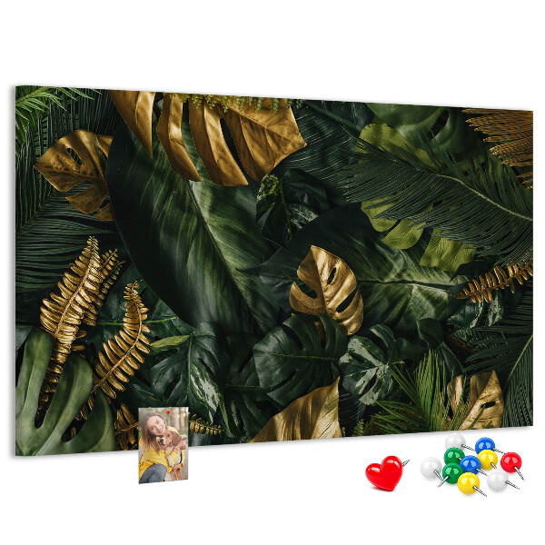 Tablero de corcho decorado con diseño de hojas doradas sobre fondo verde oscuro