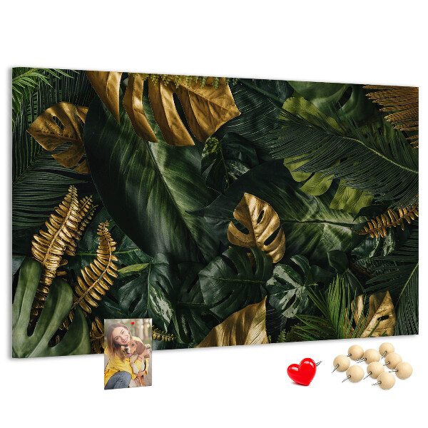 Tablero de corcho decorado con diseño de hojas doradas sobre fondo verde oscuro
