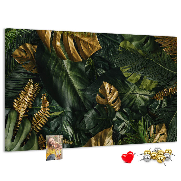 Tablero de corcho decorado con diseño de hojas doradas sobre fondo verde oscuro