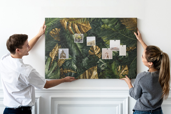 Tablero de corcho decorado con diseño de hojas doradas sobre fondo verde oscuro