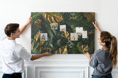 Tablero de corcho decorado con diseño de hojas doradas sobre fondo verde oscuro