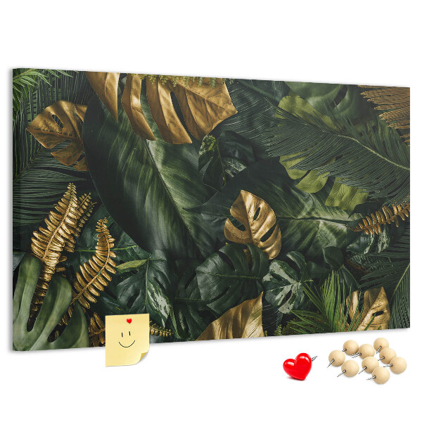 Tablero de corcho decorado con diseño de hojas doradas sobre fondo verde oscuro