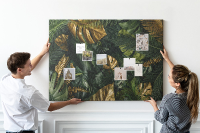 Tablero de corcho decorado con diseño de hojas doradas sobre fondo verde oscuro