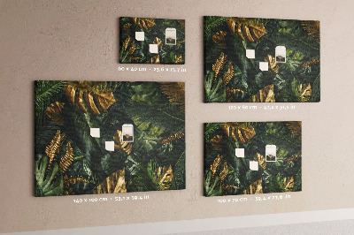 Tablero de corcho decorado con diseño de hojas doradas sobre fondo verde oscuro