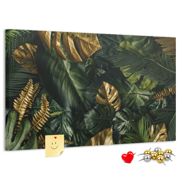 Tablero de corcho decorado con diseño de hojas doradas sobre fondo verde oscuro