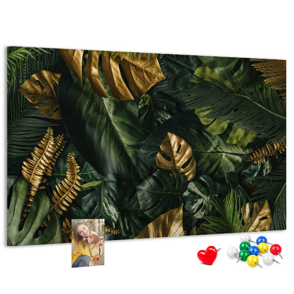 Tablero de corcho decorado con diseño de hojas doradas sobre fondo verde oscuro