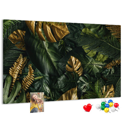 Tablero de corcho decorado con diseño de hojas doradas sobre fondo verde oscuro