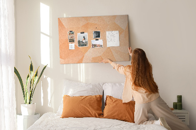 Pizarra de corcho con diseño de triángulos en tonos geométricos naranja