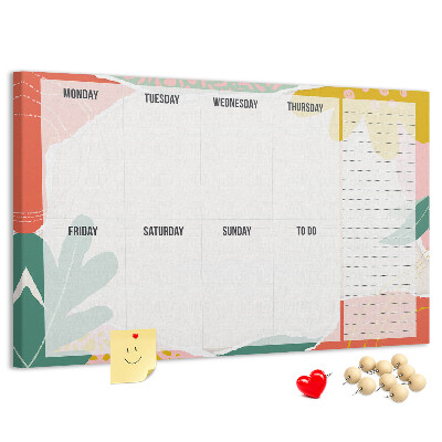 Tablero de corcho decorado con diseño de calendario floral y detalles coloridos