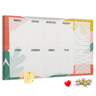 Tablero de corcho decorado con diseño de calendario floral y detalles coloridos