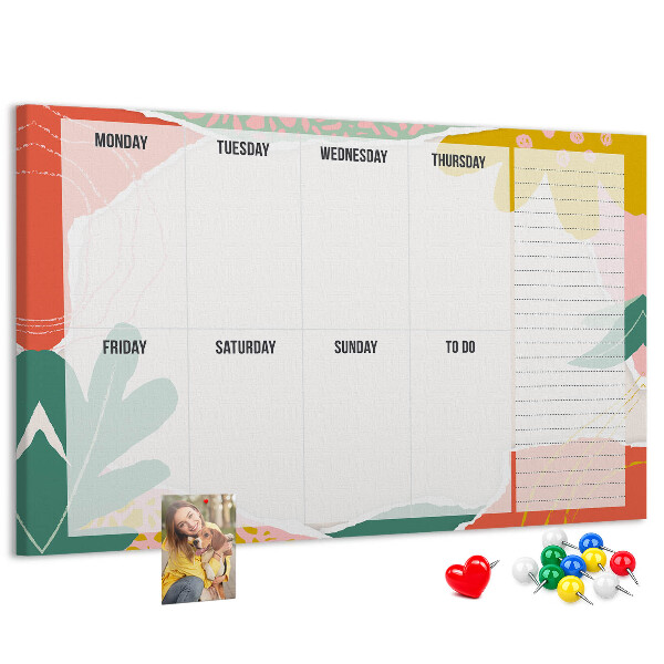 Tablero de corcho decorado con diseño de calendario floral y detalles coloridos