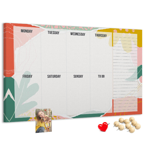 Tablero de corcho decorado con diseño de calendario floral y detalles coloridos