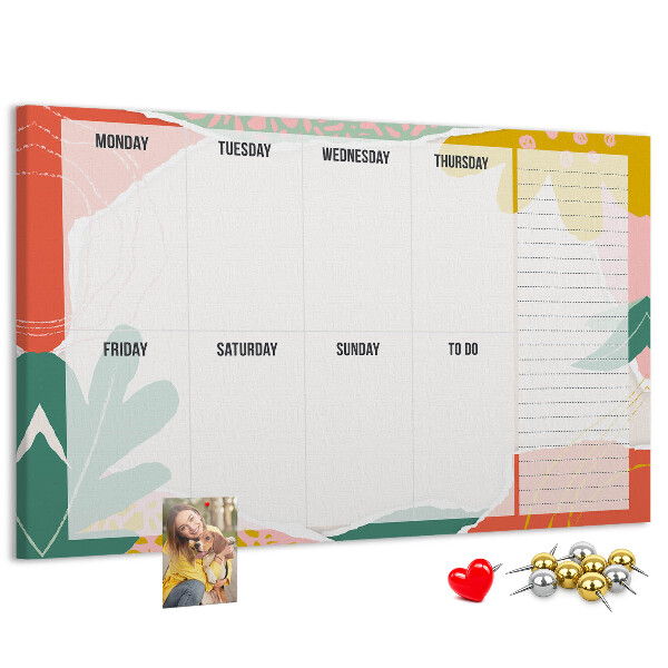 Tablero de corcho decorado con diseño de calendario floral y detalles coloridos