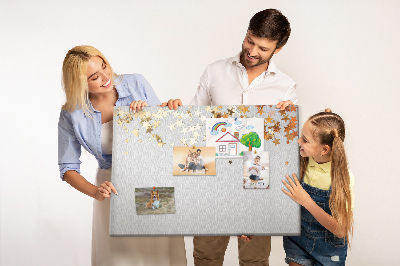 Tablero de corcho decorativo con diseño de estrellas doradas sobre fondo gris