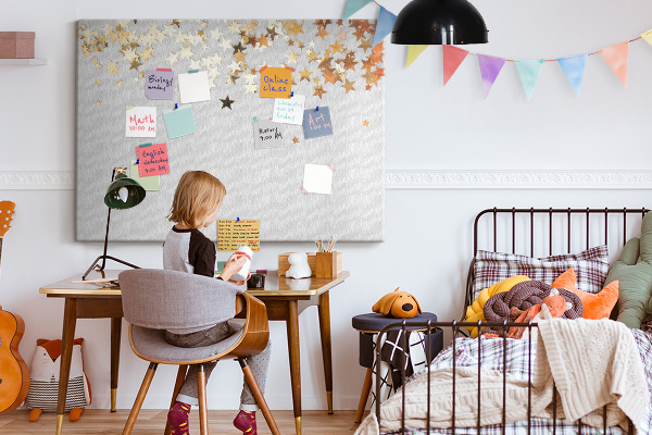 Tablero de corcho decorativo con diseño de estrellas doradas sobre fondo gris