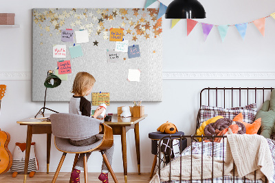 Tablero de corcho decorativo con diseño de estrellas doradas sobre fondo gris