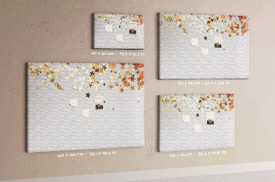 Tablero de corcho decorativo con diseño de estrellas doradas sobre fondo gris