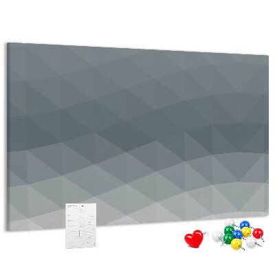 Tablero de corcho decorado con diseño de triángulos geométricos en escala de grises