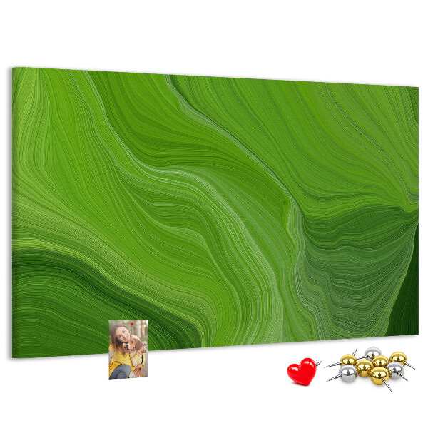 Tablero de corcho decorado con diseño de ondas verdes y líneas delicadas