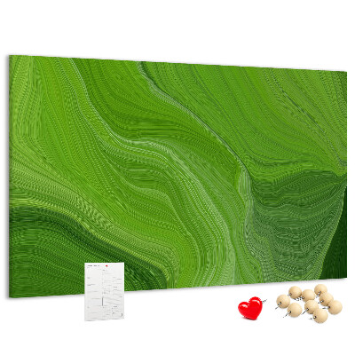 Tablero de corcho decorado con diseño de ondas verdes y líneas delicadas