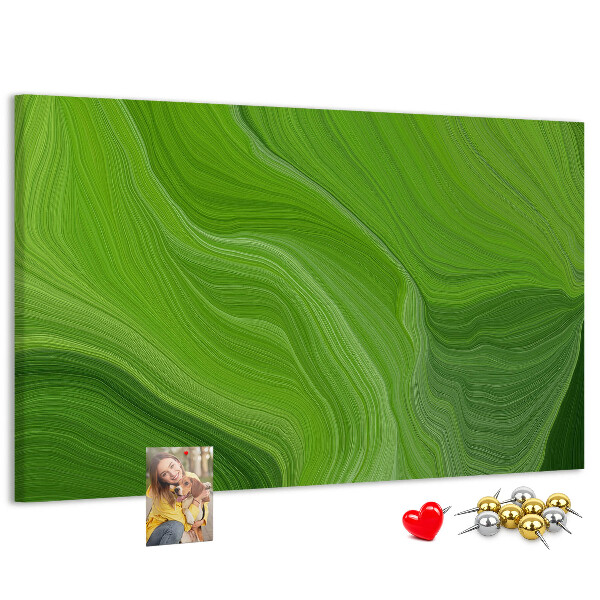 Tablero de corcho decorado con diseño de ondas verdes y líneas delicadas