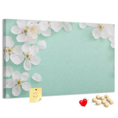 Tablero de corcho decorativo con motivos florales sobre fondo pastel