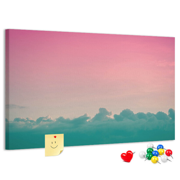 Pizarra de corcho con diseño de atardecer sobre las nubes en tonos pastel