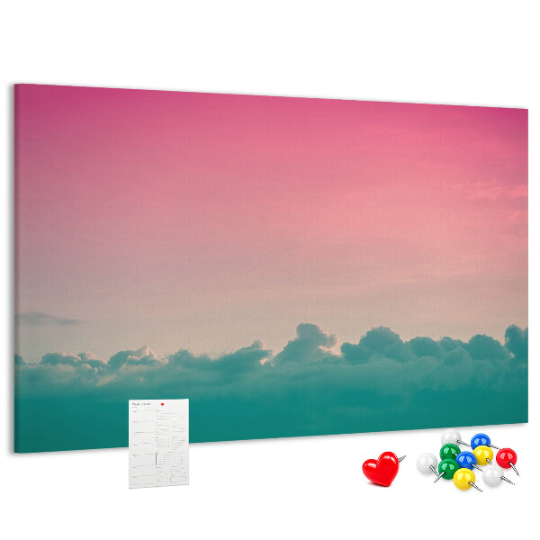 Pizarra de corcho con diseño de atardecer sobre las nubes en tonos pastel