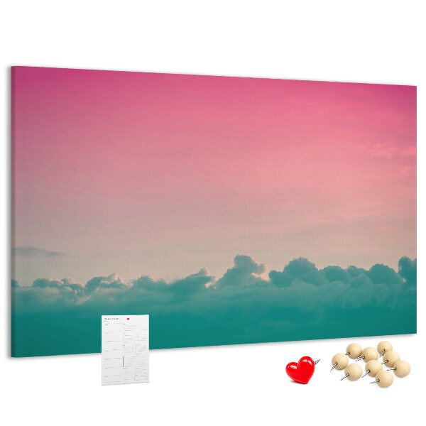 Pizarra de corcho con diseño de atardecer sobre las nubes en tonos pastel